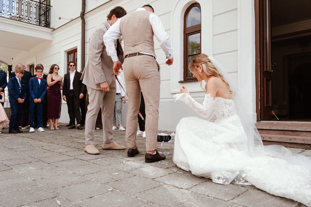 A joyful moment during a group portrait outside the chateau, wedding at Chateau Appony, Oponice