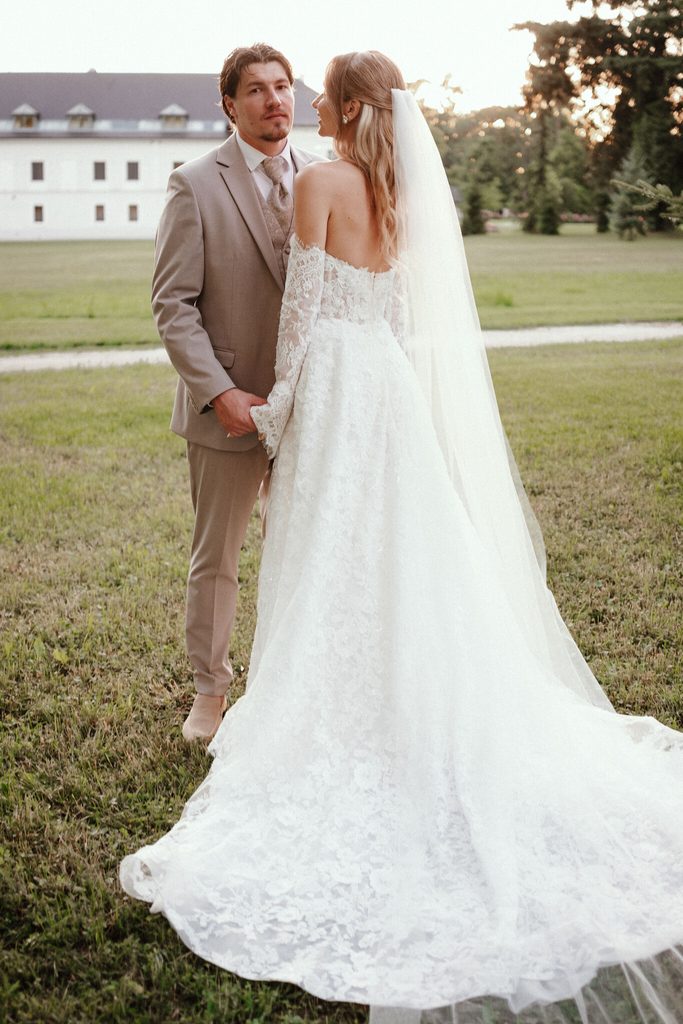 The newlyweds in a meadow outside the chateau, wedding at Chateau Appony, Oponice
