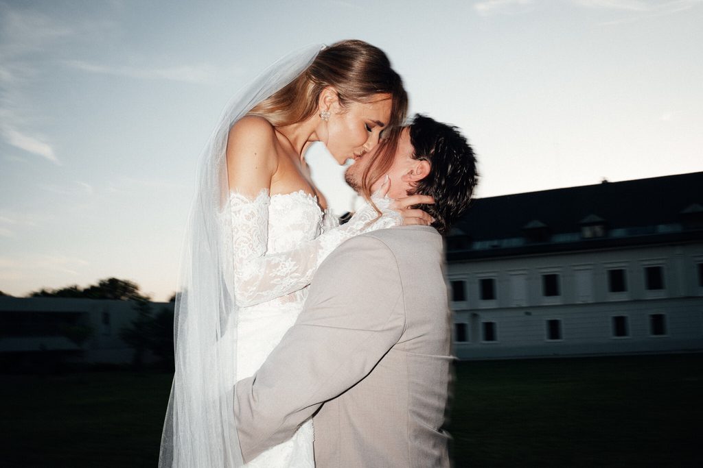 The newlyweds kissing at sunset, wedding at Chateau Appony, Oponice