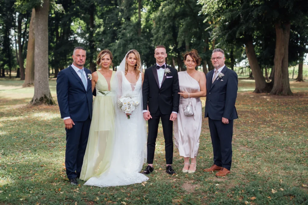 Newlyweds surrounded by family and guests after the wedding ceremony